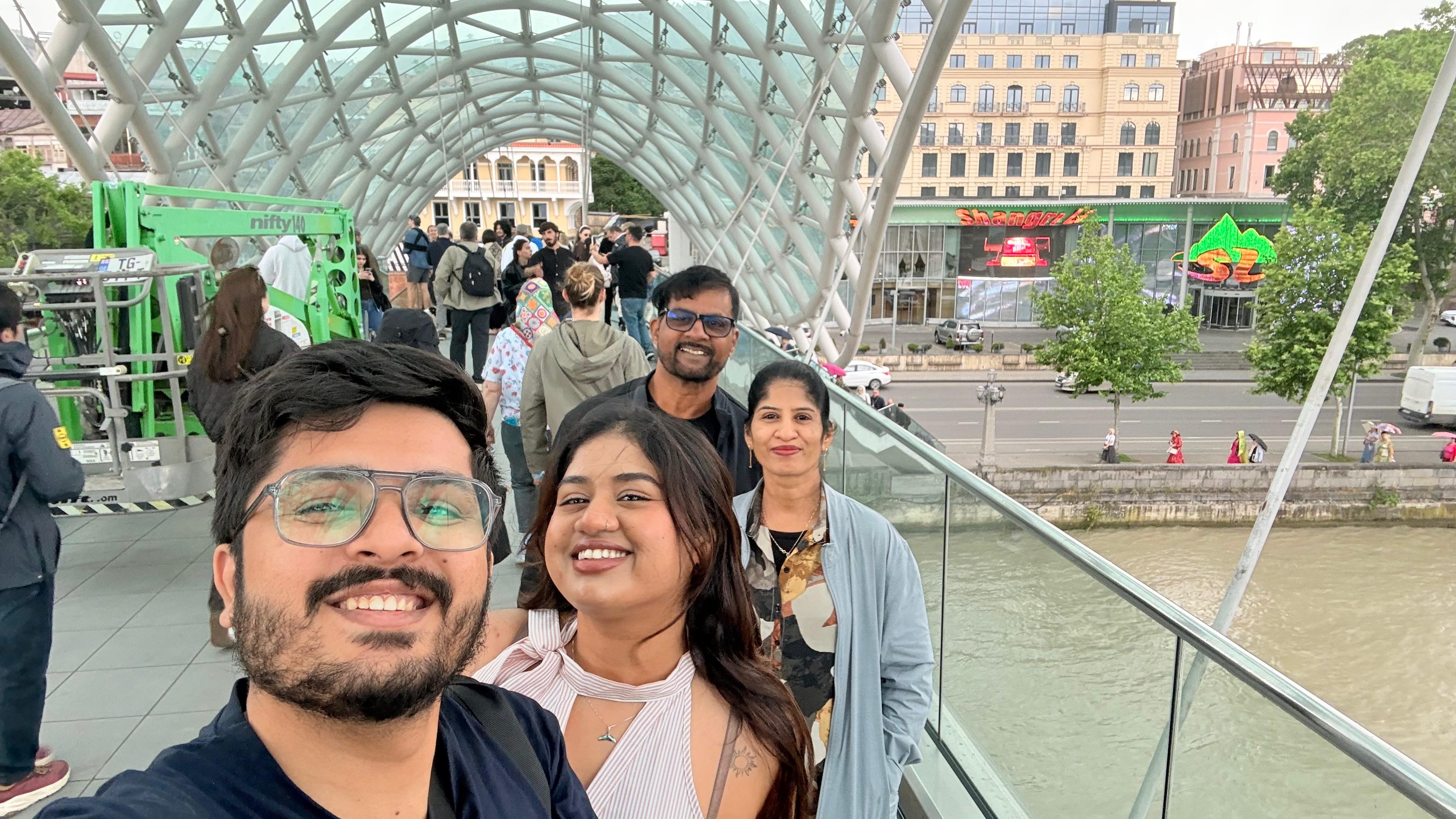 Family photo on a glass bridge in Tbilisi