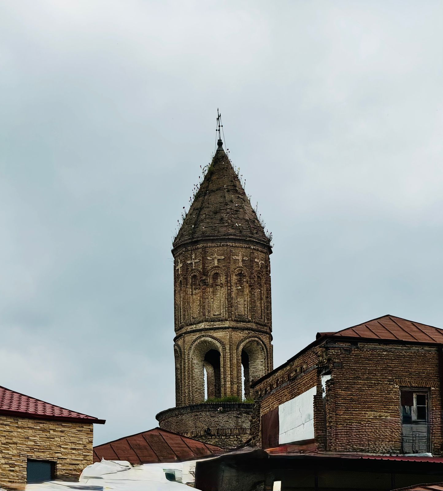 Historic Georgian monastery under cloudy skies